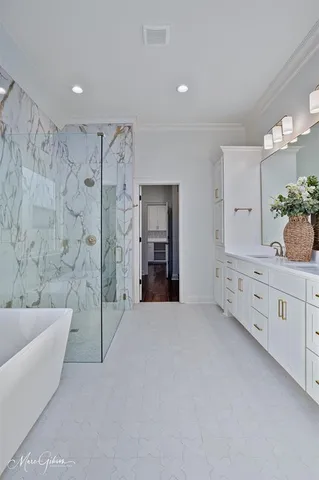 a large spacious bathroom with a tub shower and mirror