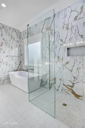 a bathroom with a bathtub and shower