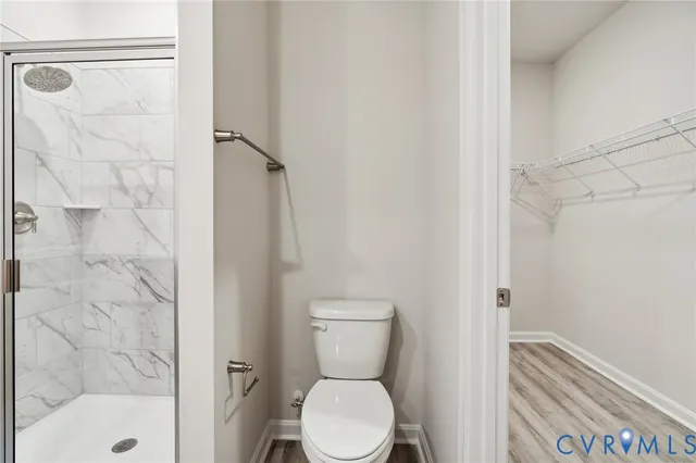 a bathroom with a toilet and a shower