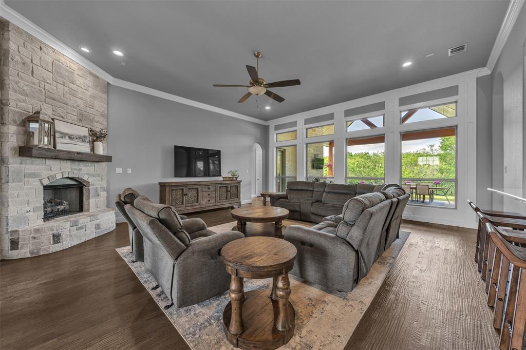 1060 Waters Edge Court Oak Point, TX 75068 - Photo 7 of 40 a living room with fireplace furniture and a large window