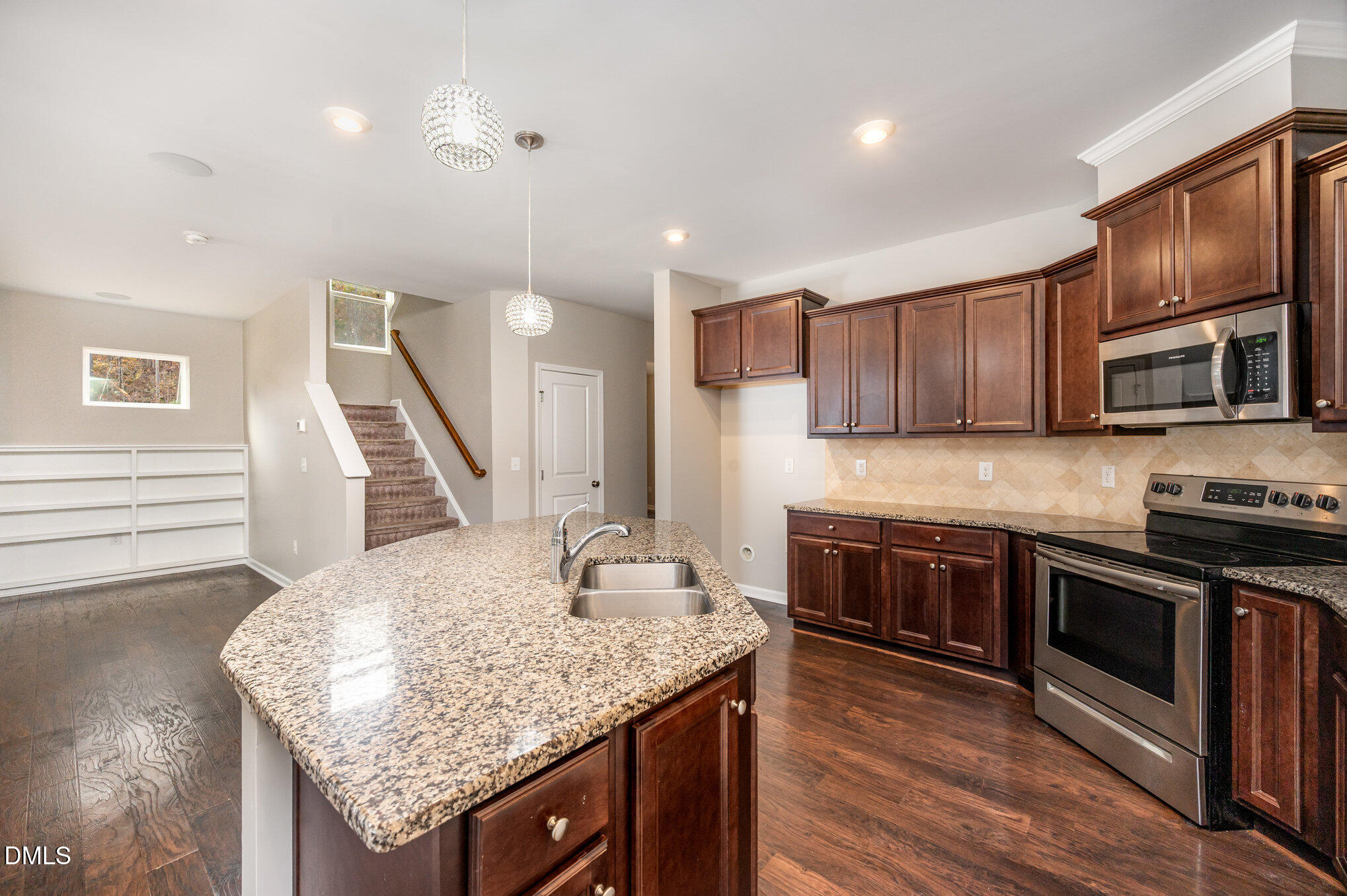 18 Dover Ridge Court Chapel Hill, NC 27517 - Photo 10 of 40 a kitchen with stainless steel appliances granite countertop a kitchen island hardwood floor sink and stove