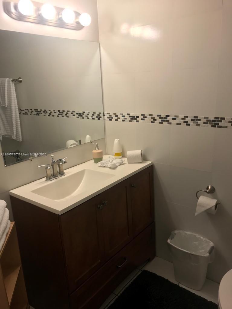26 Diplomat Parkway, Unit 2233 Hallandale Beach, FL 33009 - Photo 5 of 7 a bathroom with a sink and a toilet