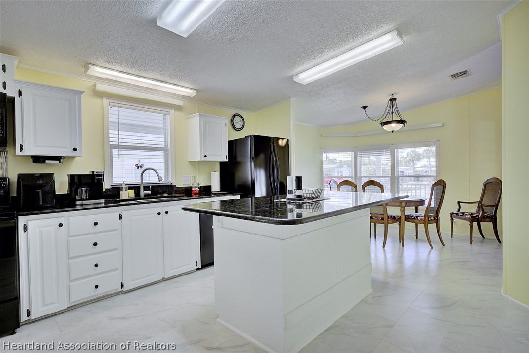 2702 Rodney Street Sebring, FL 33872 - Photo 8 of 33 a kitchen with sink and cabinets