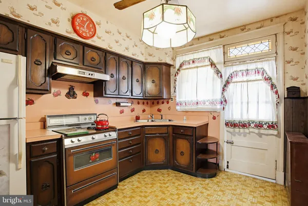 a kitchen with stainless steel appliances a stove a refrigerator and a sink