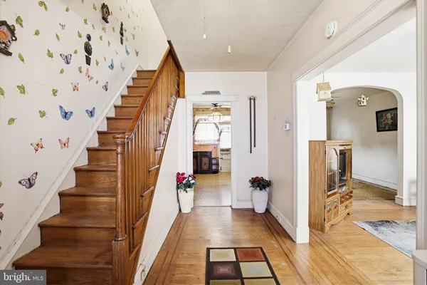 a view of entryway and hall with wooden floor