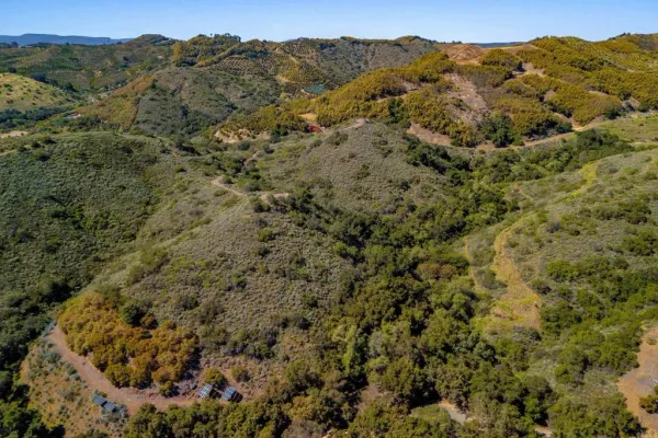 a view of a mountain range with trees in the background