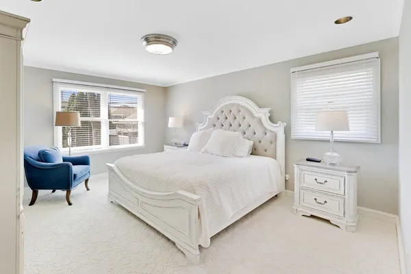 a bedroom with a bed and a chair