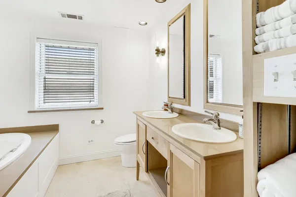 a bathroom with a sink a toilet and a mirror