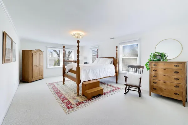 a bedroom with furniture and a dresser