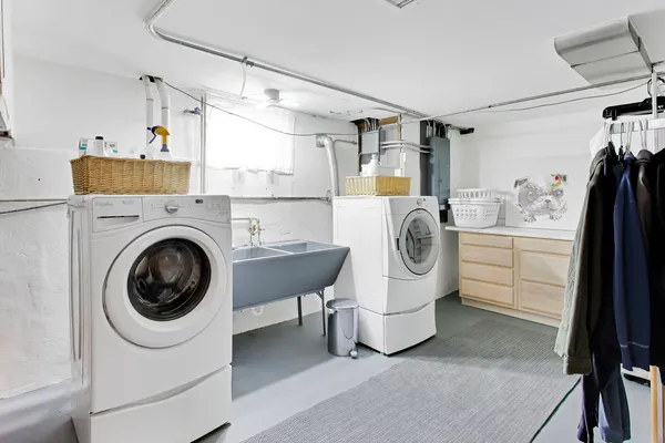 a utility room with sink dryer and washer