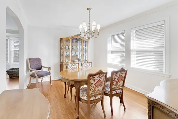 a view of a dining room with furniture and a chandelier