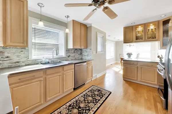 a kitchen with stainless steel appliances a sink stove and cabinets