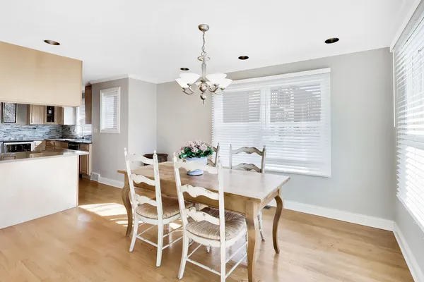 a view of a dining room with furniture and a chandelier