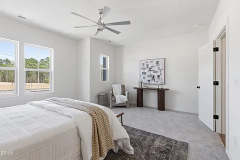 a bedroom with a bed and window