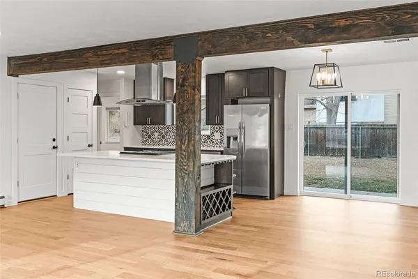 a kitchen with stainless steel appliances granite countertop a refrigerator and a sink