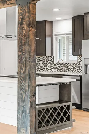 a kitchen with a stove and a wooden floor