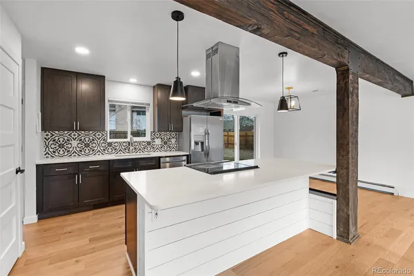 a living room with fireplace furniture and a wooden floor