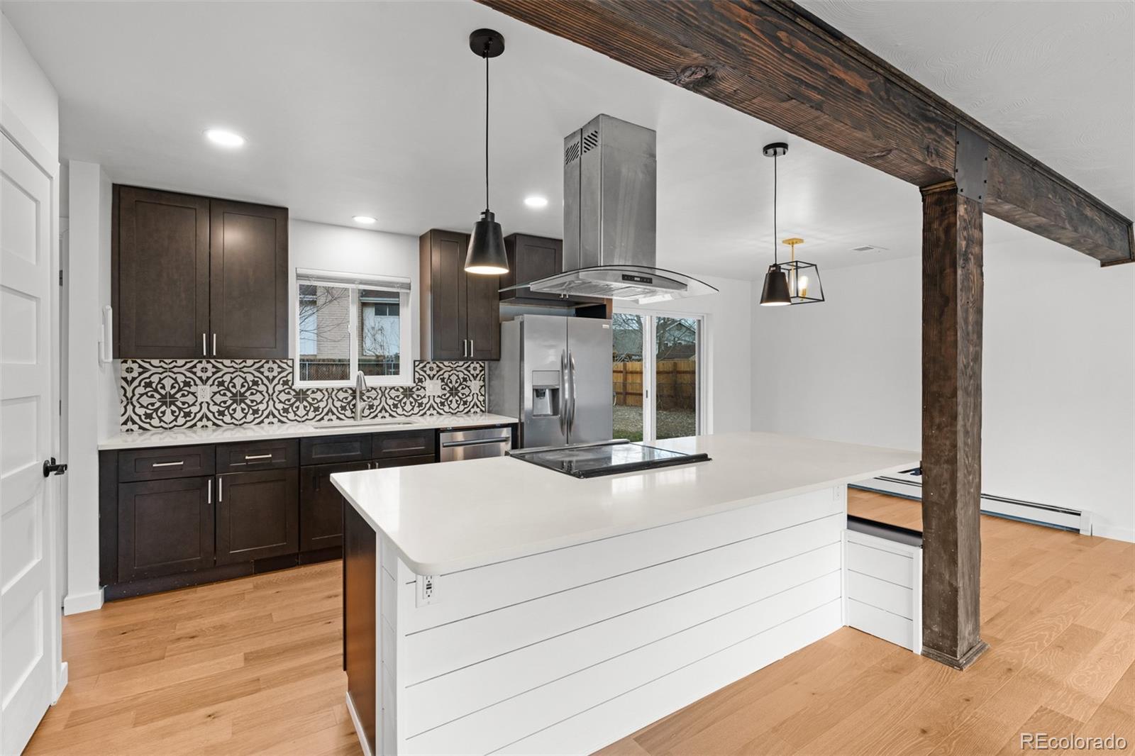 1440 Northwestern Road Longmont, CO 80503 - Photo 18 of 41 a kitchen with stainless steel appliances kitchen island granite countertop a sink and a refrigerator