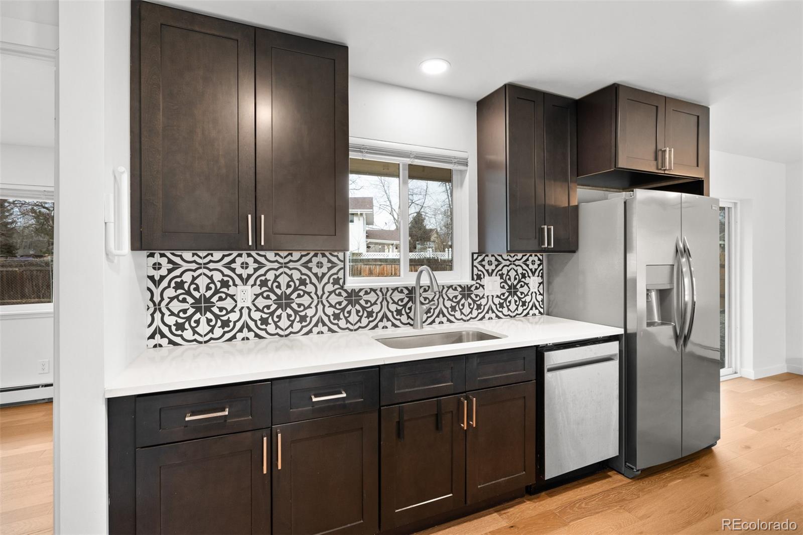 1440 Northwestern Road Longmont, CO 80503 - Photo 19 of 41 a kitchen with stainless steel appliances granite countertop a refrigerator and a sink