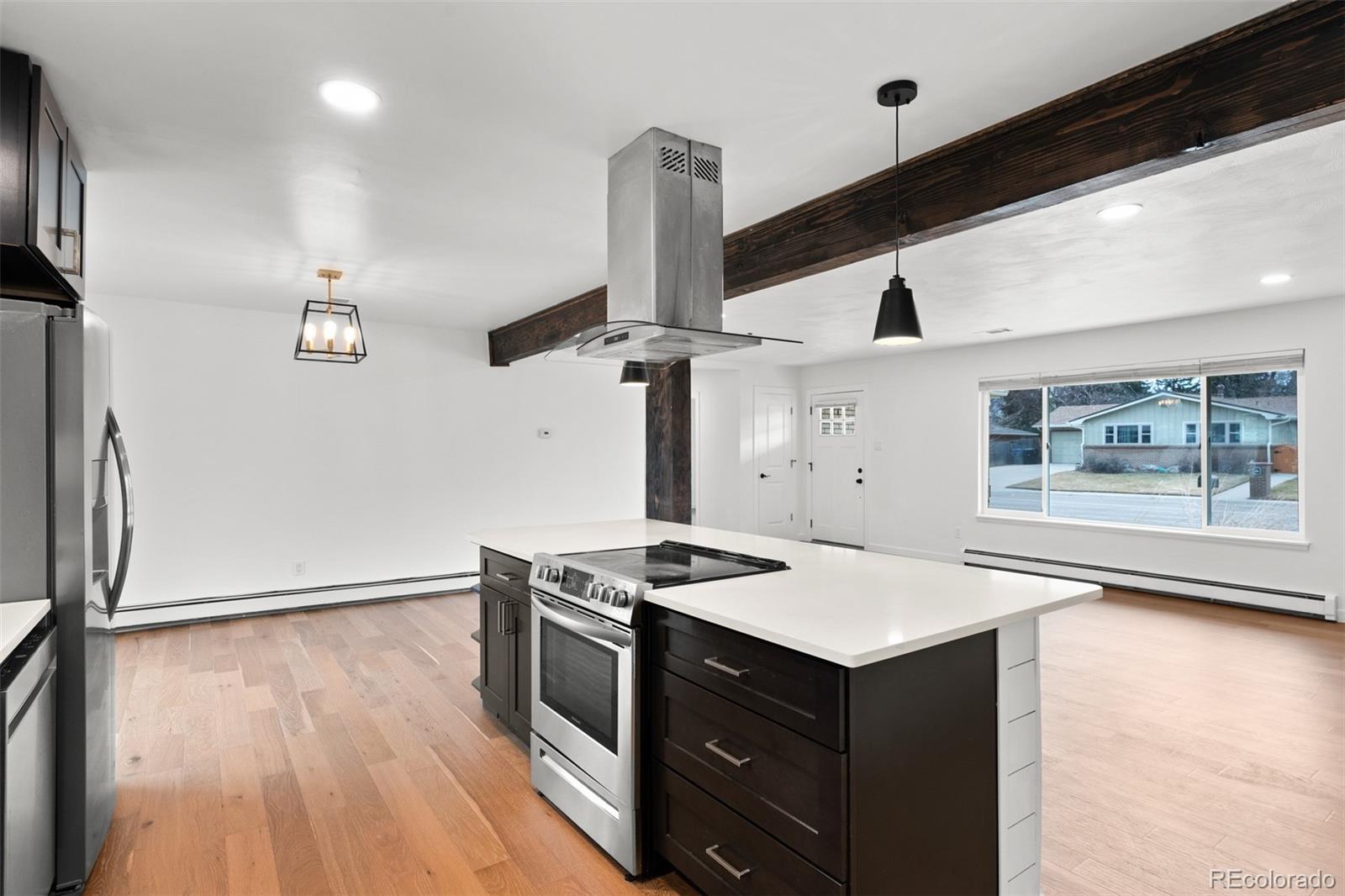 1440 Northwestern Road Longmont, CO 80503 - Photo 20 of 41 a kitchen with a stove and a wooden floor
