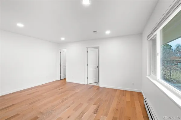 a bathroom with a granite countertop sink a toilet and a mirror