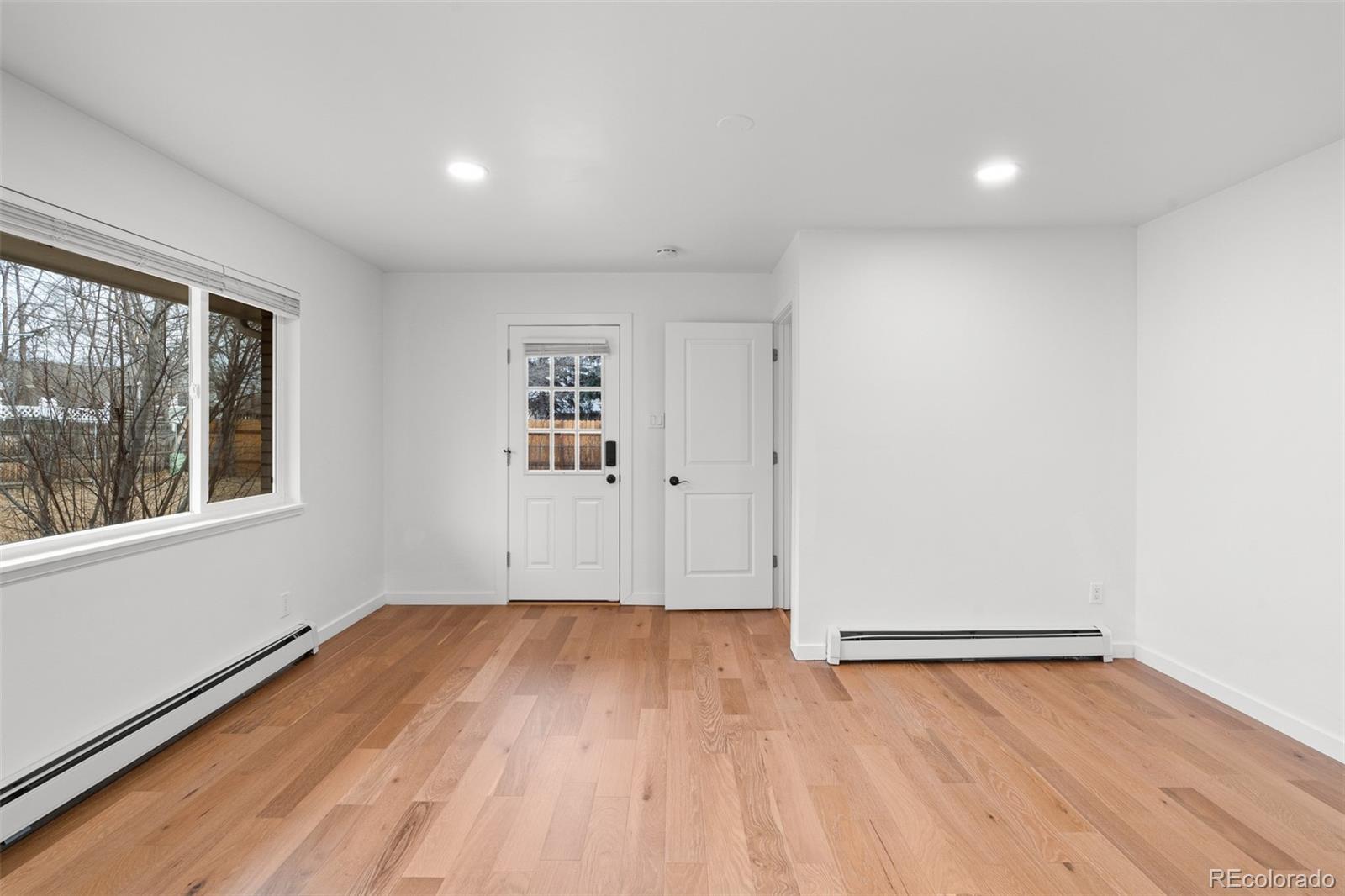 1440 Northwestern Road Longmont, CO 80503 - Photo 27 of 41 an empty room with wooden floor and windows