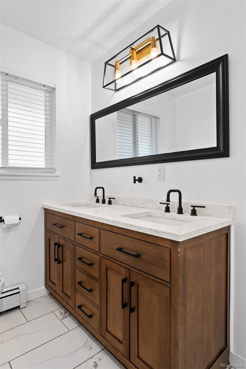 1440 Northwestern Road Longmont, CO 80503 - Photo 28 of 41 a bathroom with a sink and a mirror