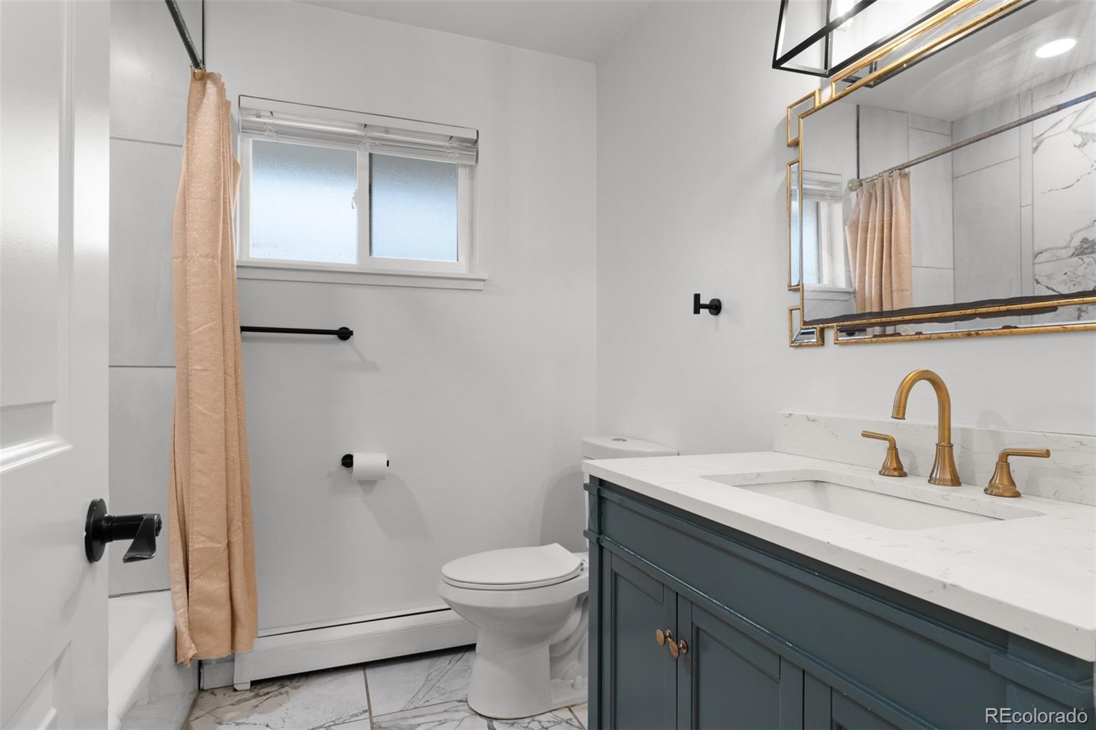 1440 Northwestern Road Longmont, CO 80503 - Photo 36 of 41 a bathroom with a granite countertop sink a toilet and a mirror