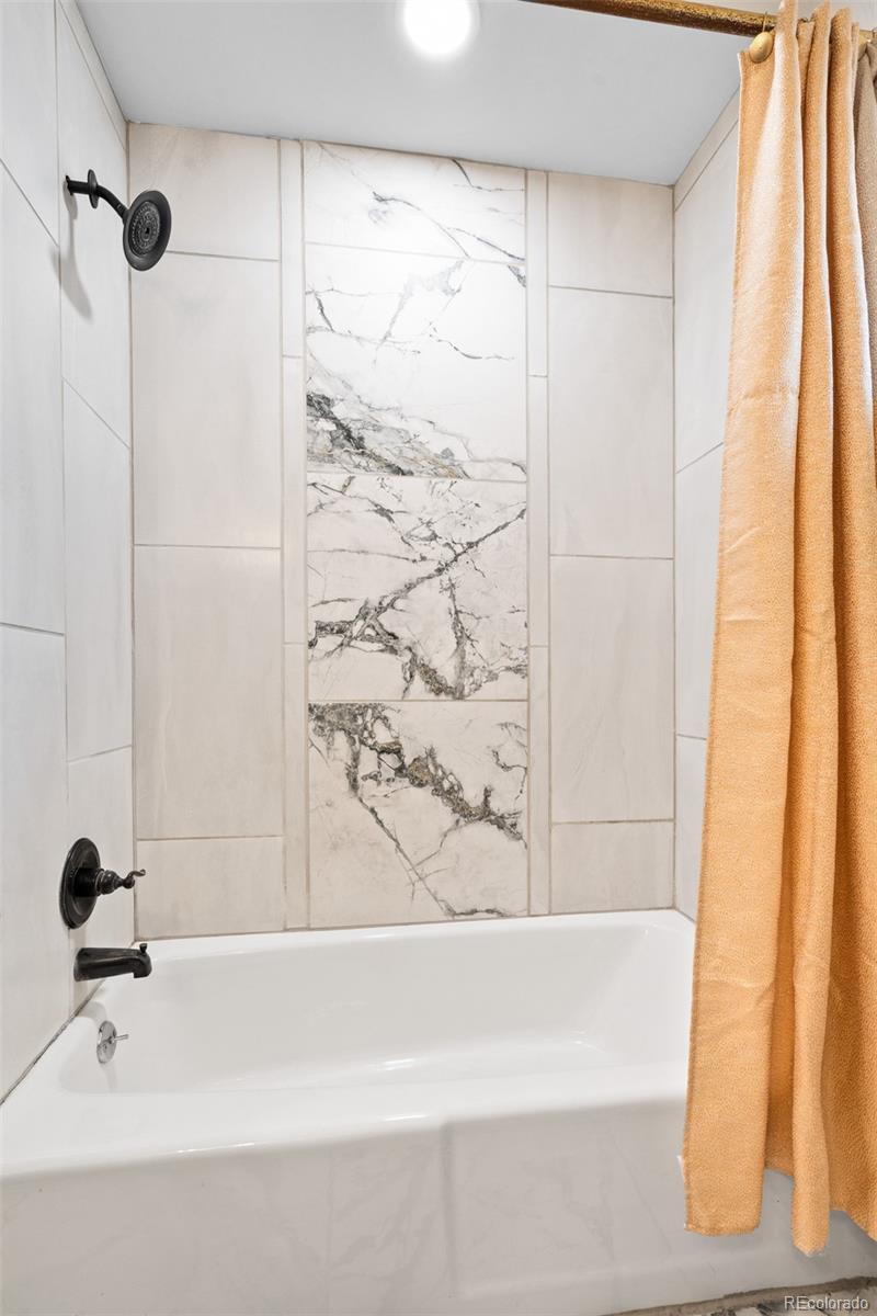 1440 Northwestern Road Longmont, CO 80503 - Photo 38 of 41 a bathroom with a bathtub and shower
