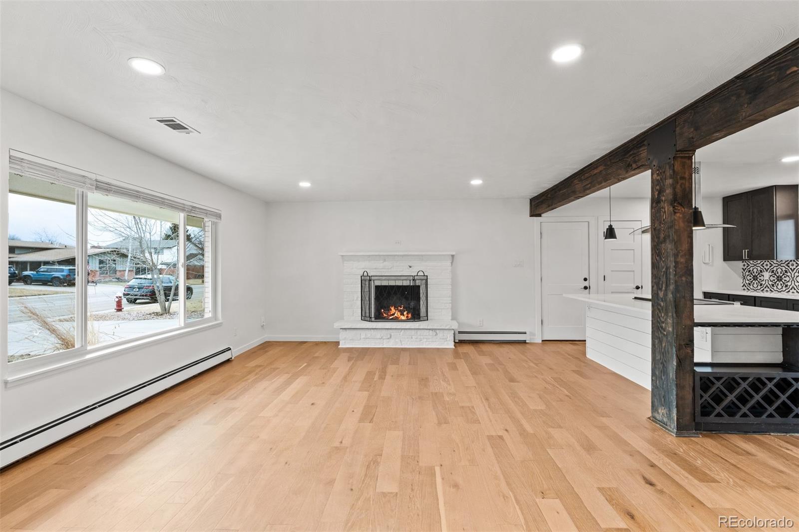 1440 Northwestern Road Longmont, CO 80503 - Photo 6 of 41 a view of an empty room with a window and fire place