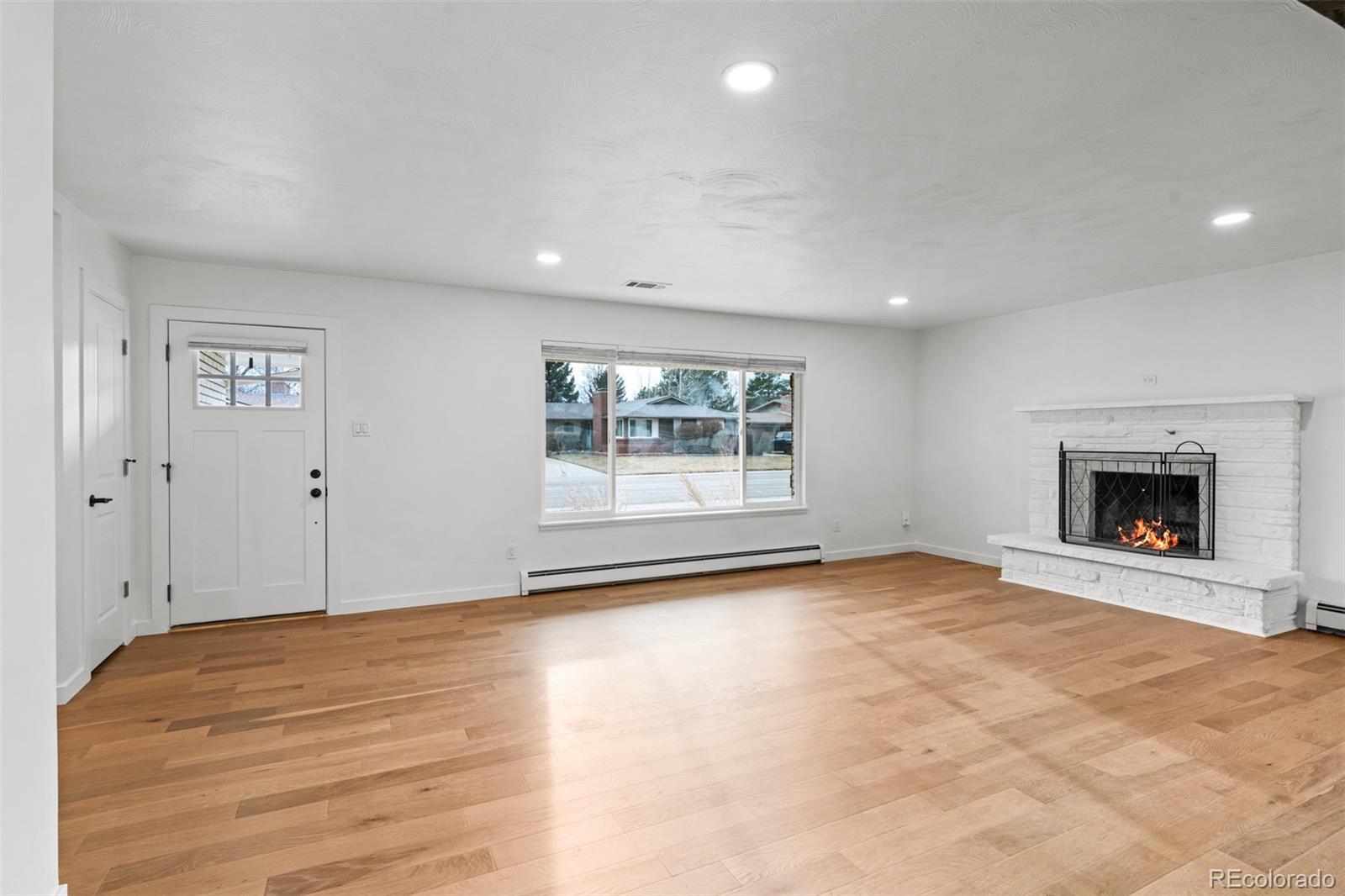1440 Northwestern Road Longmont, CO 80503 - Photo 9 of 41 a view of an empty room with a window and fireplace