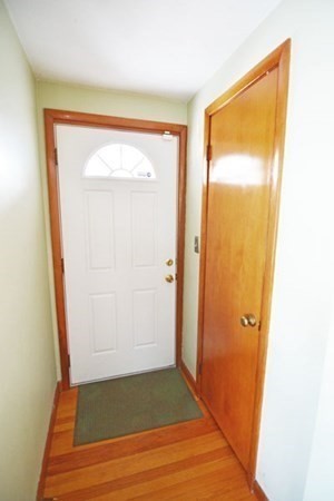 21 Hadley Street Springfield, MA 01118 - Photo 12 of 34 an empty room with wooden floor and a door