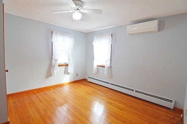 21 Hadley Street Springfield, MA 01118 - Photo 13 of 34 a view of an empty room with wooden floor and a window