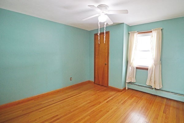 21 Hadley Street Springfield, MA 01118 - Photo 19 of 34 an empty room with wooden floor and windows