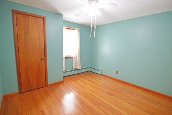 21 Hadley Street Springfield, MA 01118 - Photo 20 of 34 an empty room with wooden floor closet and windows
