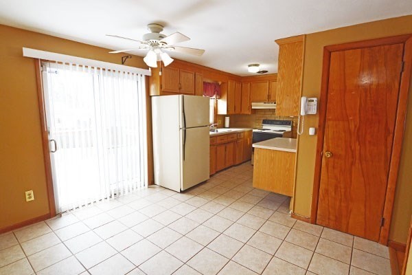 21 Hadley Street Springfield, MA 01118 - Photo 3 of 34 a kitchen with stainless steel appliances a refrigerator and a refrigerator