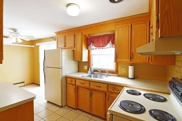 21 Hadley Street Springfield, MA 01118 - Photo 5 of 34 a kitchen with a refrigerator and a stove