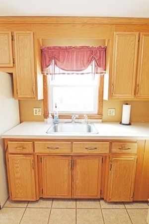 21 Hadley Street Springfield, MA 01118 - Photo 6 of 34 a kitchen with cabinets and window