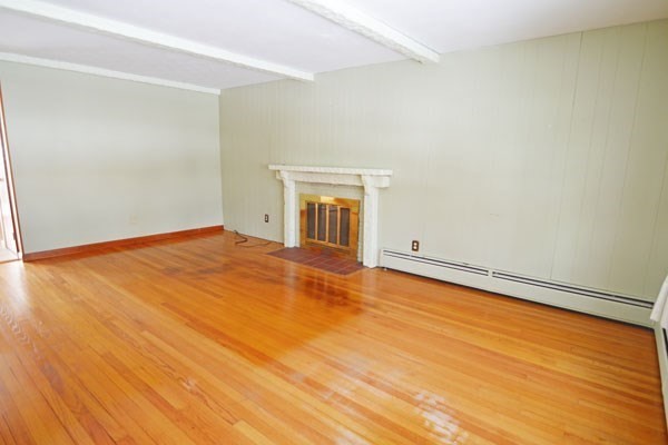 21 Hadley Street Springfield, MA 01118 - Photo 10 of 34 an empty room with wooden floor and windows