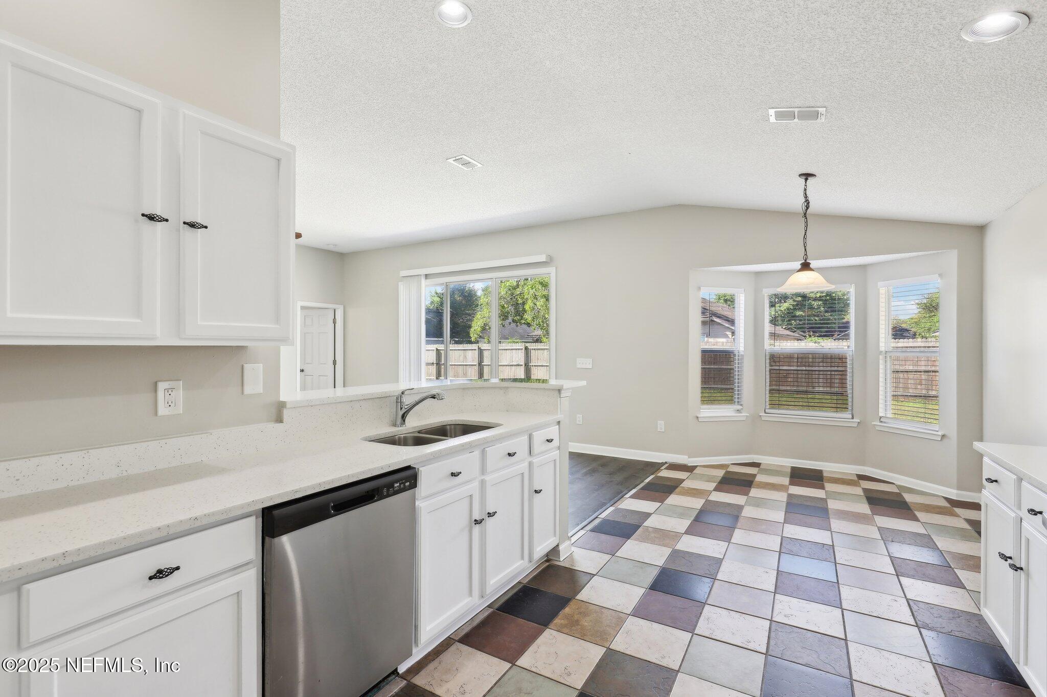 86123 Red Holly Place Yulee, FL 32097 - Photo 15 of 36 a kitchen with a sink a window and cabinets
