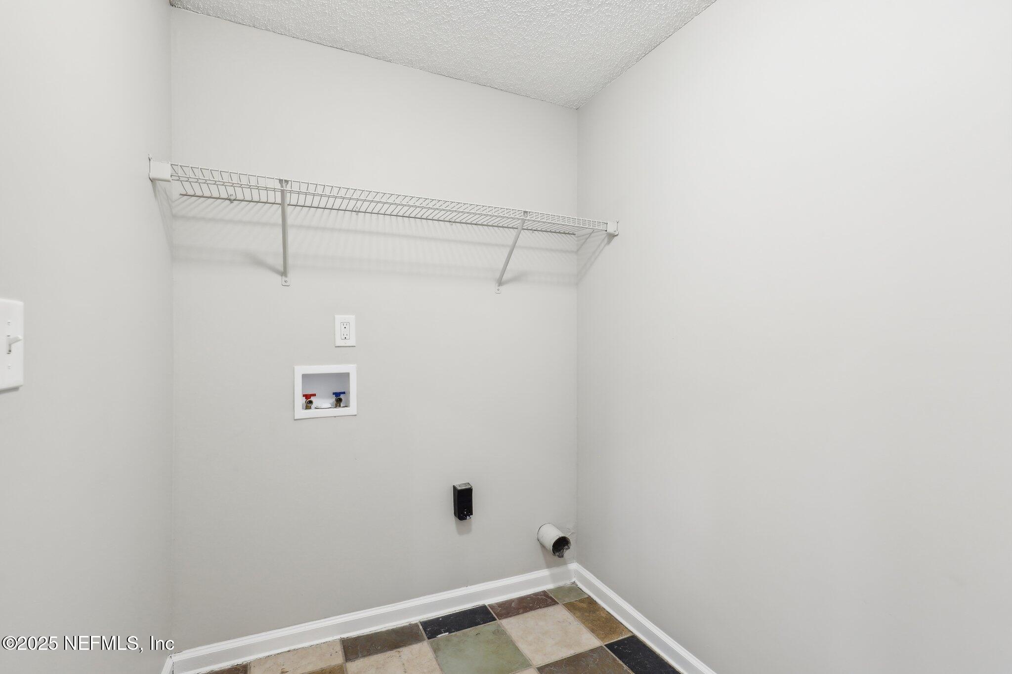 86123 Red Holly Place Yulee, FL 32097 - Photo 18 of 36 a view of a room with racks on the wall