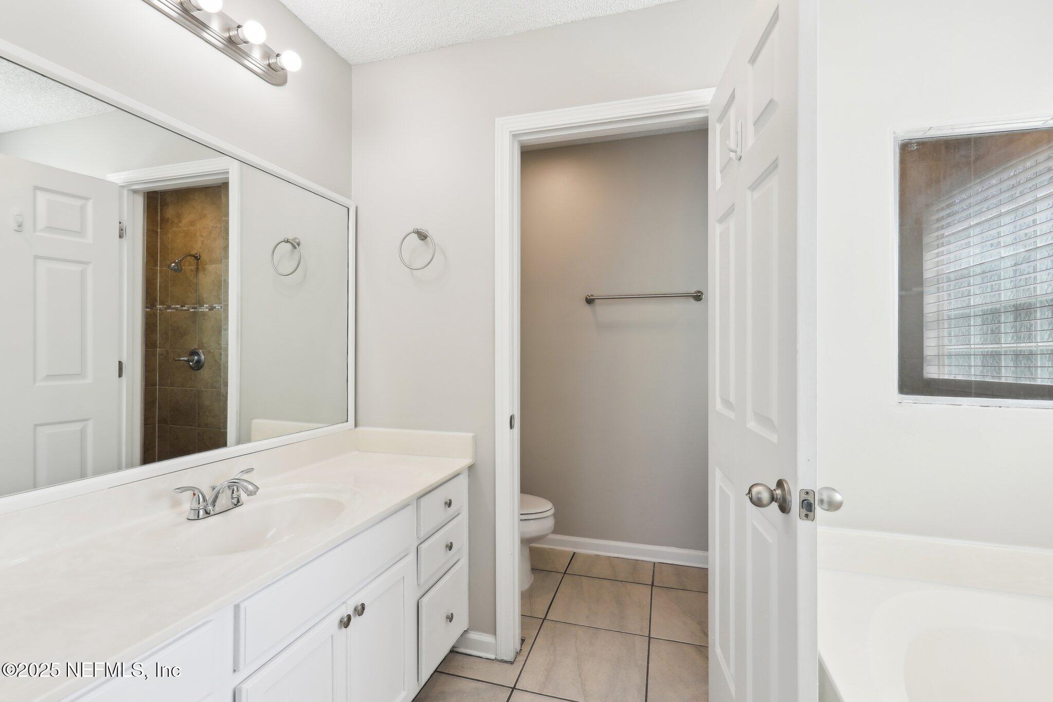 86123 Red Holly Place Yulee, FL 32097 - Photo 29 of 36 a bathroom with a sink a toilet and shower