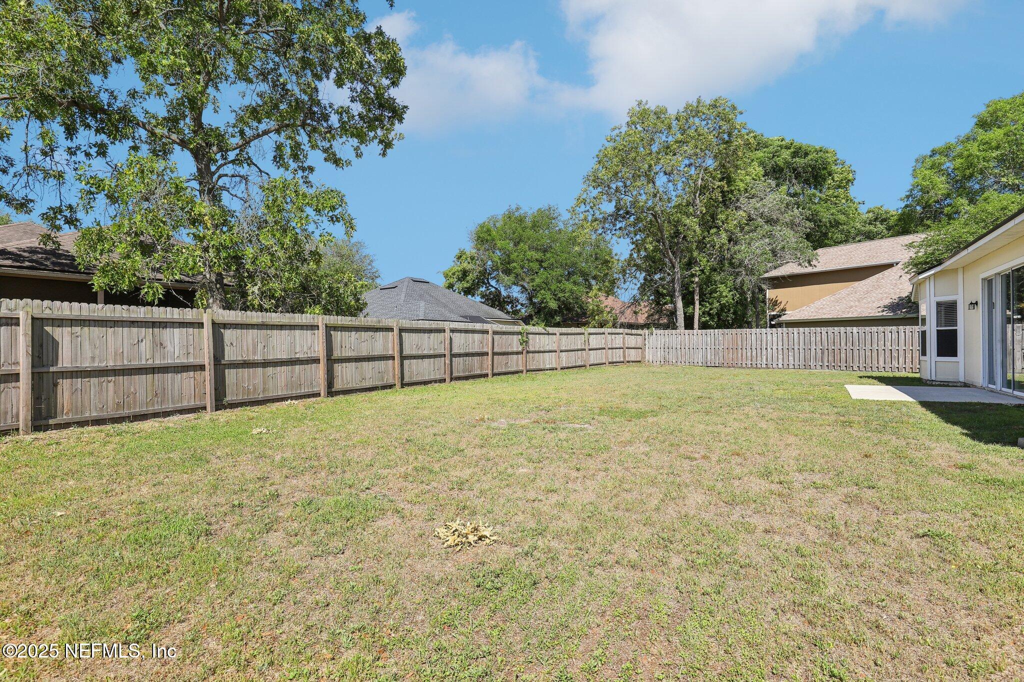 86123 Red Holly Place Yulee, FL 32097 - Photo 33 of 36 a view of backyard and tree