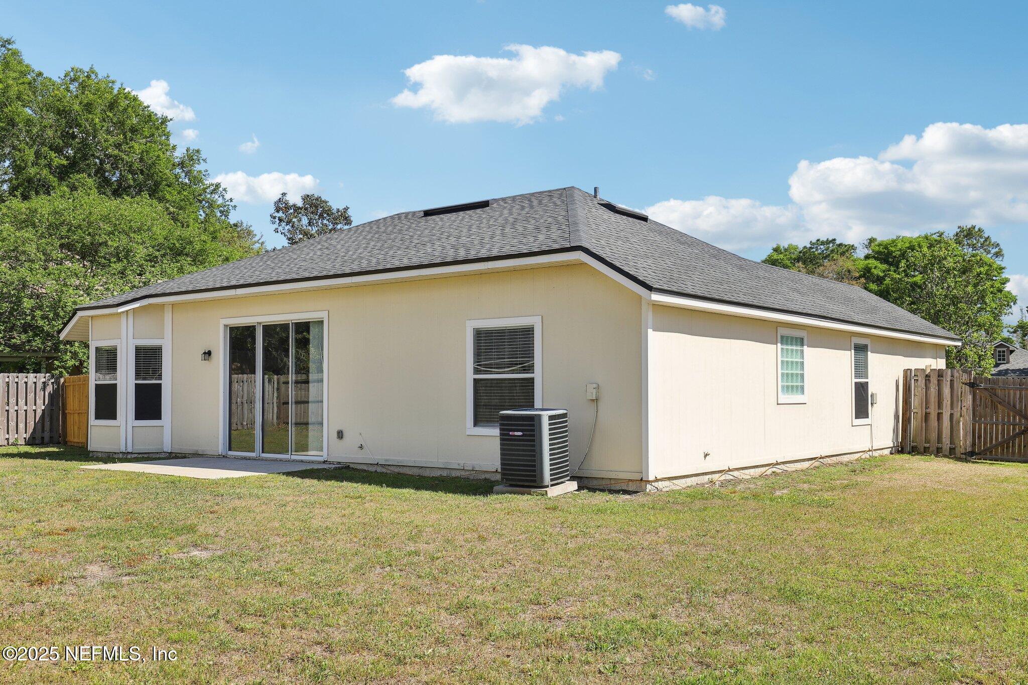 86123 Red Holly Place Yulee, FL 32097 - Photo 34 of 36 a house with trees in front of it