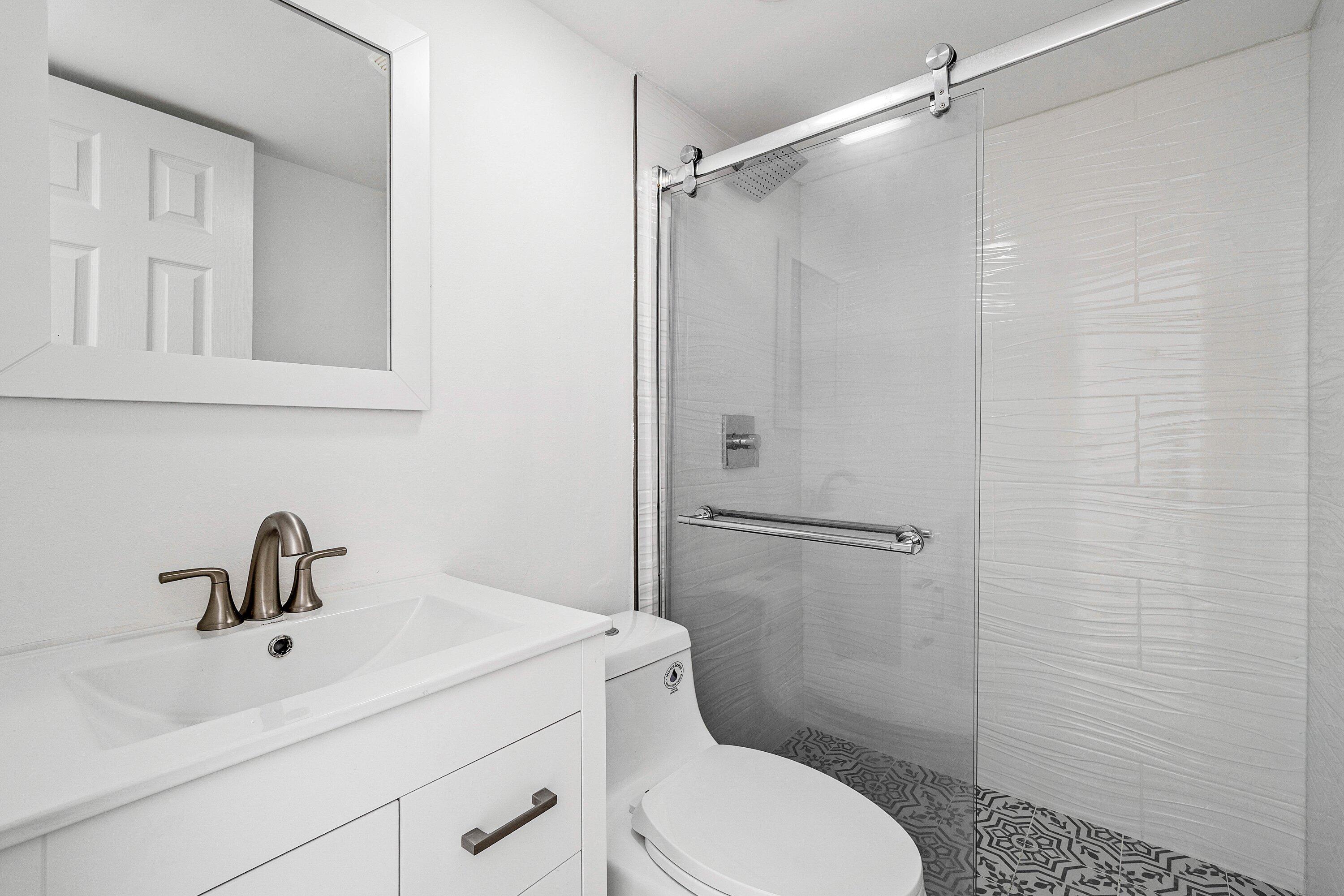 1531 Northwest 4th Street Boca Raton, FL 33486 - Photo 19 of 34 a bathroom with a sink toilet and shower