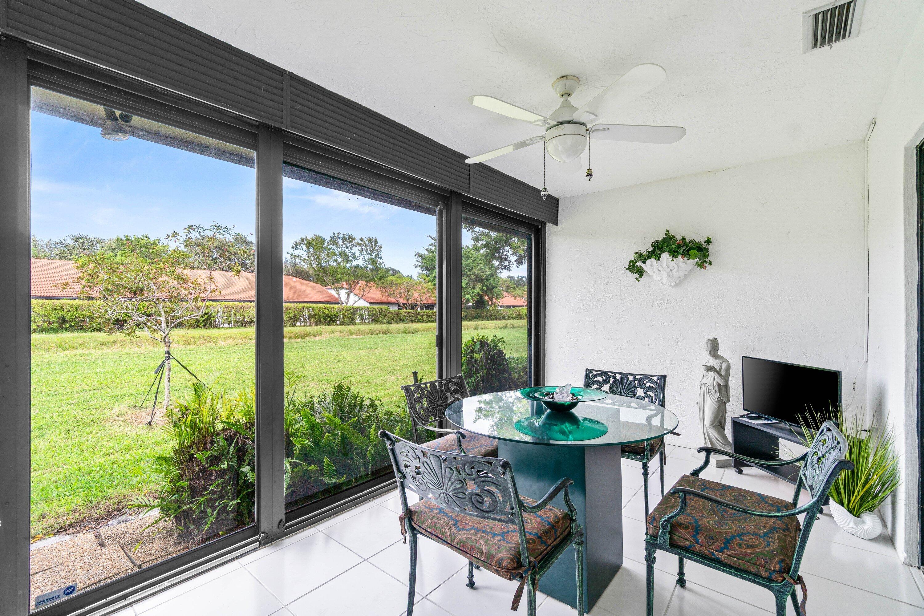 8191 Whispering Palm Drive Boca Raton, FL 33496 - Photo 23 of 34 a dining room with furniture water view and a floor to ceiling window