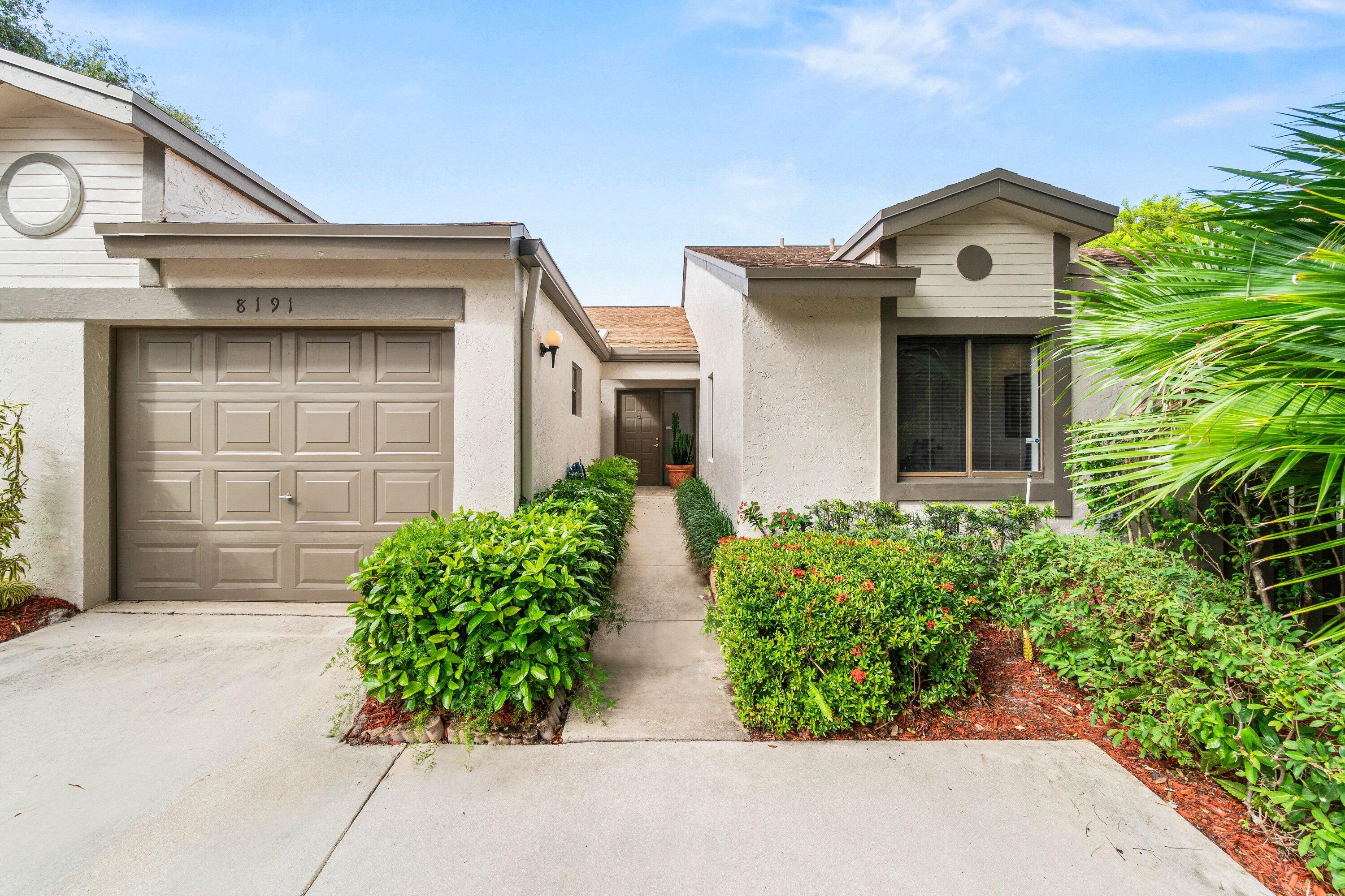 8191 Whispering Palm Drive Boca Raton, FL 33496 - Photo 4 of 34 front view of house with potted plants