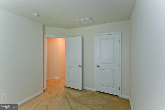 an empty room with closet area