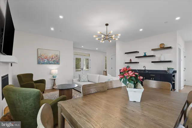 a living room with furniture potted plant and wooden floor