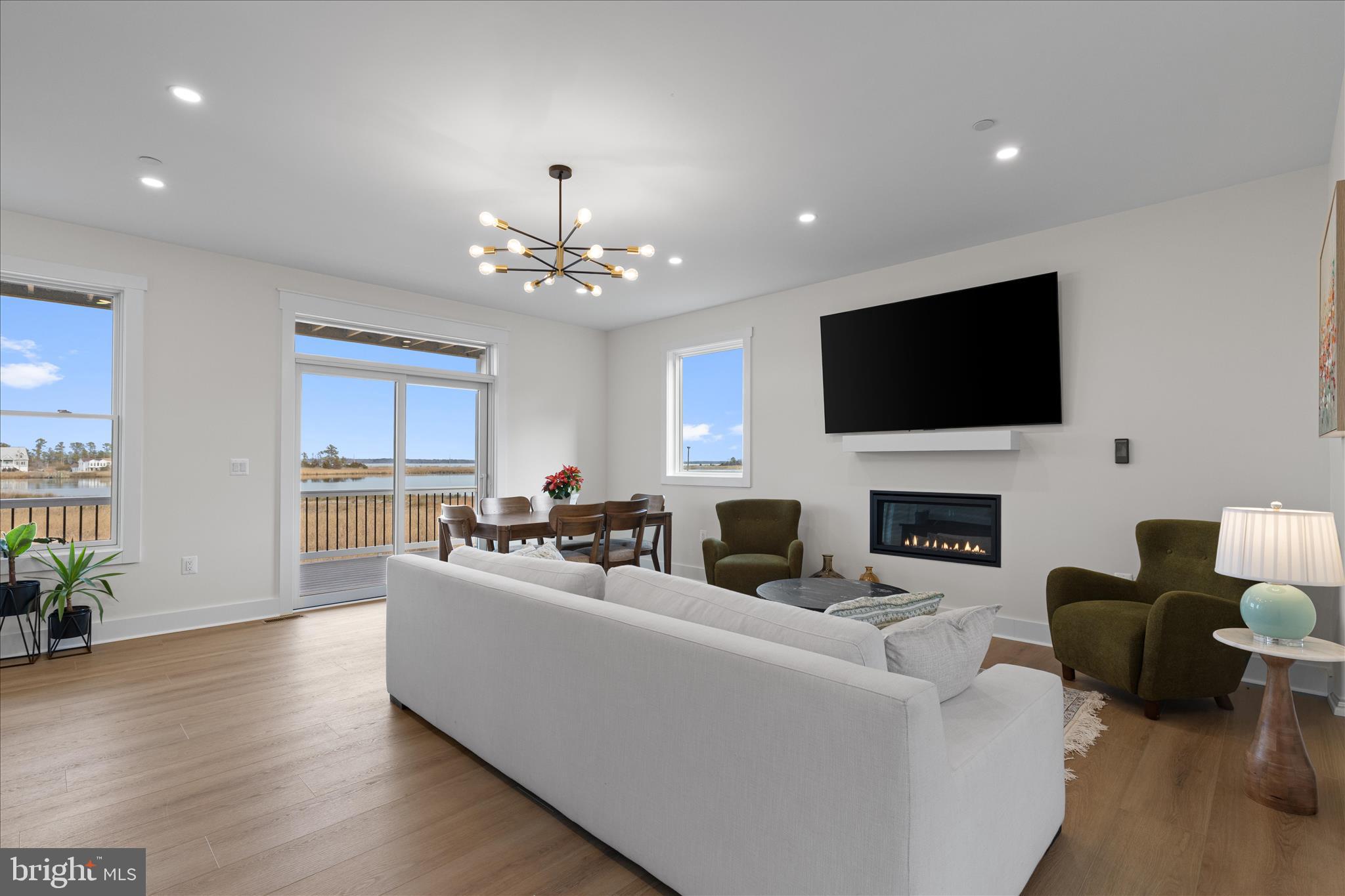 16242 Thomas Road Piney Point, MD 20674 - Photo 17 of 75 a living room with fireplace furniture and a flat screen tv
